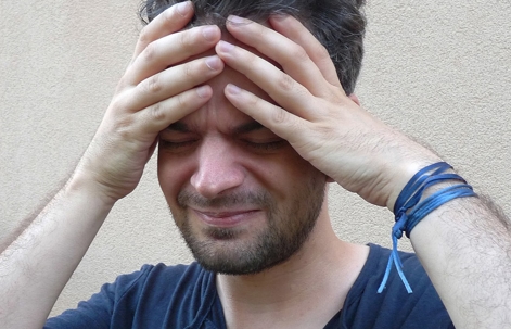 Man holding hands on head