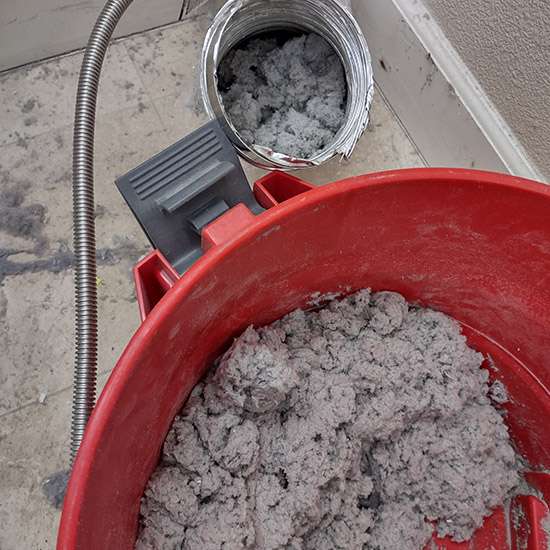 dryer lint removed from a clogged residential clothes dryer