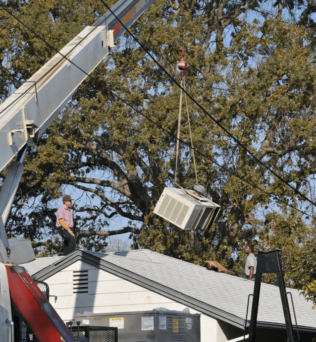 Using a crane to install a packaged rooftop AC unit in Livermore